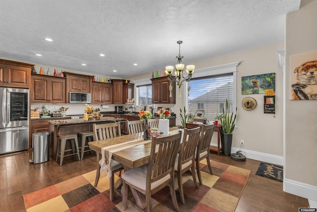 3308 Brickyard Ave, Rock Springs, WY 82901 - dining area with a chandelier, a textured ceiling, recessed lighting, and dark wood-style flooring