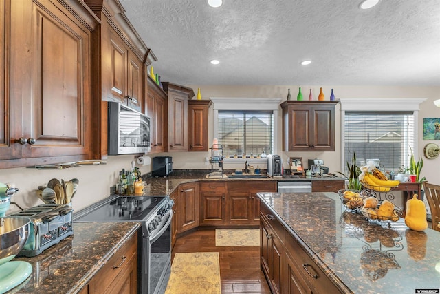 3308 Brickyard Ave, Rock Springs, WY 82901 - kitchen with stainless steel appliances, a textured ceiling, healthy amount of natural light, recessed lighting, and dark wood finished floors