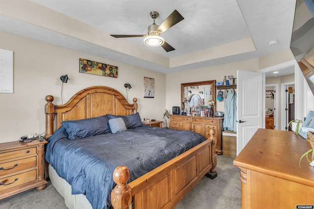 3308 Brickyard Ave, Rock Springs, WY 82901 - bedroom featuring light carpet, a raised ceiling, and a ceiling fan