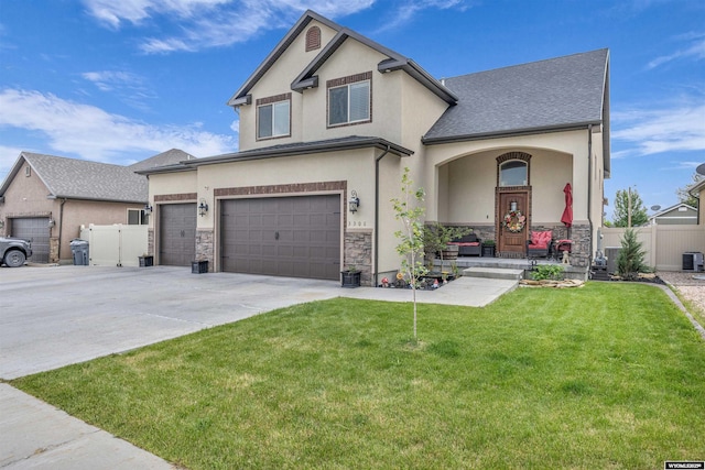 3308 Brickyard Ave, Rock Springs, WY 82901 - view of front of house with concrete driveway, stucco siding, stone siding, and a porch