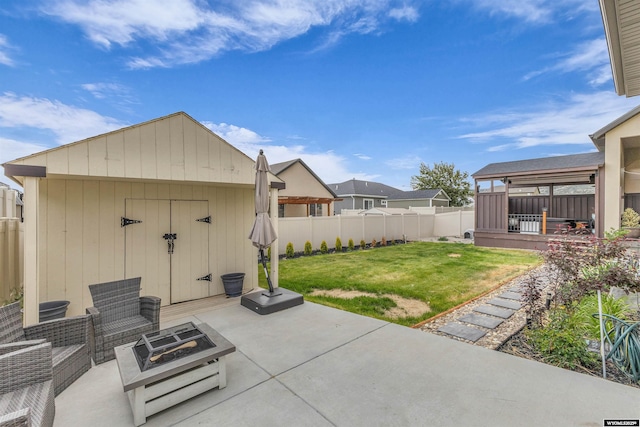 3308 Brickyard Ave, Rock Springs, WY 82901 - fenced backyard with a fire pit, a patio, and a shed