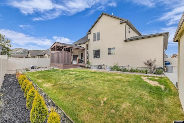 3308 Brickyard Ave, Rock Springs, WY 82901 - rear view of house featuring a gazebo, stucco siding, and a fenced backyard