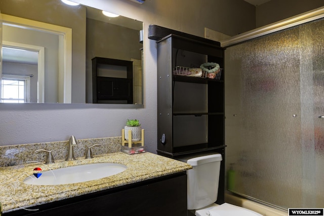 2634 Hanway Ave, Casper, WY 82604 - bathroom with vanity and combined bath / shower with glass door