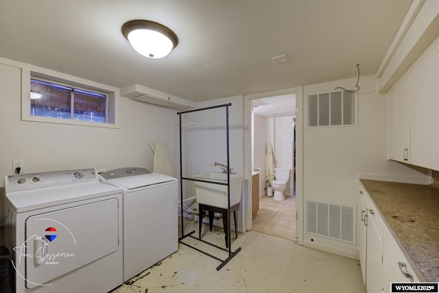 2634 Hanway Ave, Casper, WY 82604 - washroom with washing machine and clothes dryer and cabinet space