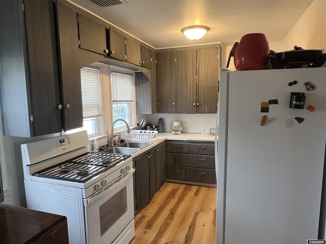 2617 E B St, Torrington, WY 82240 - kitchen featuring white appliances, light wood finished floors, and light countertops