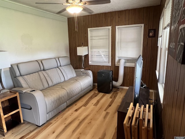 2617 E B St, Torrington, WY 82240 - living area with a ceiling fan, light wood-style floors, and wood walls