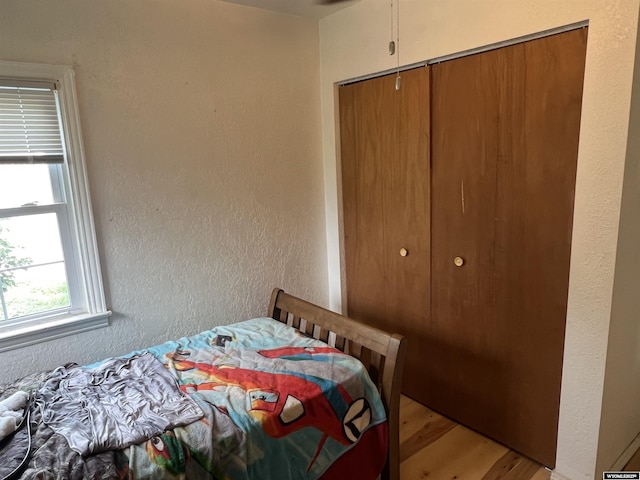 2617 E B St, Torrington, WY 82240 - bedroom with light wood-style floors, a closet, and a textured wall