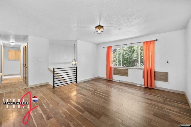65 Calypso St, Casper, WY 82604 - empty room featuring wood finished floors and a textured ceiling