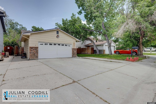 1821 S Mckinley St, Casper, WY 82601 - view of front of property featuring brick siding, concrete driveway, and a garage