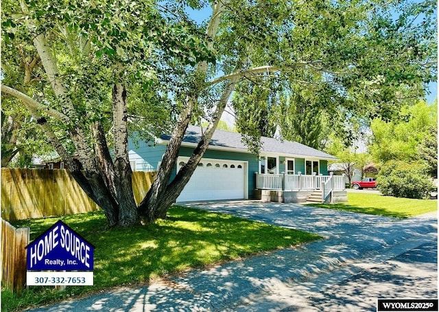 418 Spire Dr, Riverton, WY 82501 - view of front of home featuring driveway, a garage, and covered porch