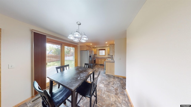 418 Spire Dr, Riverton, WY 82501 - dining space featuring stone finish floors, a chandelier, and recessed lighting