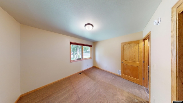 418 Spire Dr, Riverton, WY 82501 - unfurnished bedroom featuring light colored carpet and baseboards