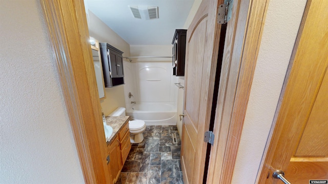 418 Spire Dr, Riverton, WY 82501 - bathroom featuring stone finish floors, vanity, and bathtub / shower combination