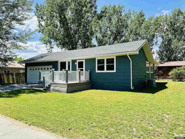 418 Spire Dr, Riverton, WY 82501 - single story home featuring an attached garage, driveway, roof with shingles, and a deck