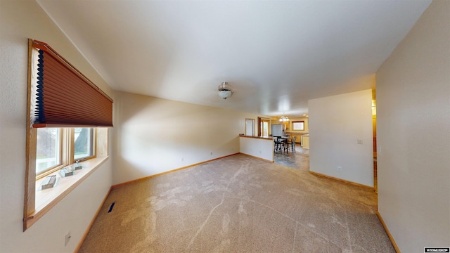 418 Spire Dr, Riverton, WY 82501 - unfurnished living room featuring carpet flooring and baseboards
