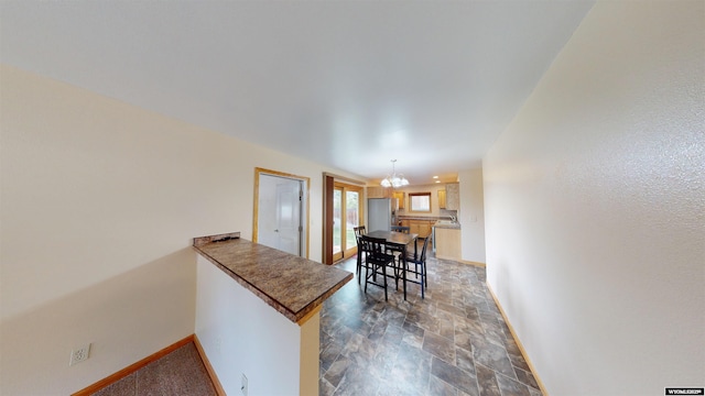 418 Spire Dr, Riverton, WY 82501 - dining space featuring stone finish floors and a chandelier