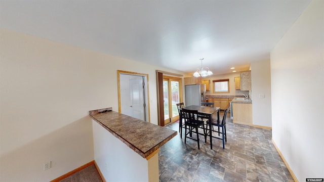418 Spire Dr, Riverton, WY 82501 - dining space with a chandelier and stone finish flooring