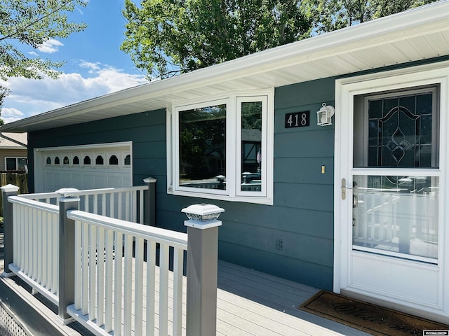 418 Spire Dr, Riverton, WY 82501 - view of exterior entry with a garage and a deck