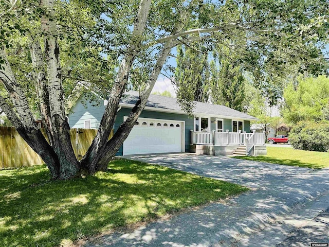 418 Spire Dr, Riverton, WY 82501 - view of front of house featuring asphalt driveway, a garage, and a porch