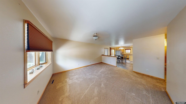 418 Spire Dr, Riverton, WY 82501 - unfurnished living room with carpet and baseboards