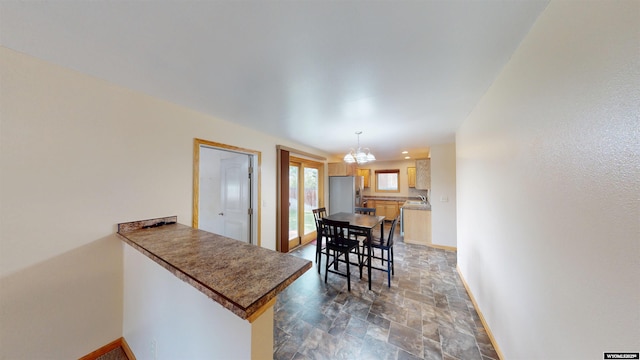 418 Spire Dr, Riverton, WY 82501 - dining room with stone finish flooring and a chandelier