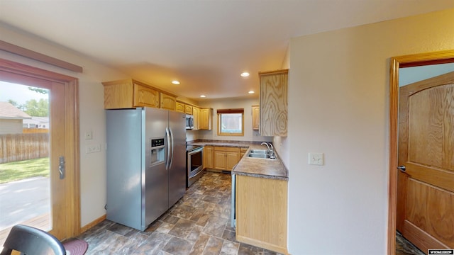 418 Spire Dr, Riverton, WY 82501 - kitchen featuring appliances with stainless steel finishes, stone finish floors, recessed lighting, and light brown cabinetry