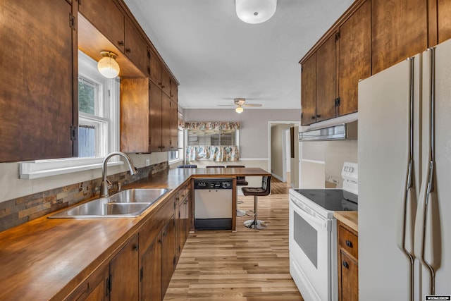 922 New Hampshire St, Rock Springs, WY 82901 - kitchen with white appliances, light wood finished floors, healthy amount of natural light, and a peninsula