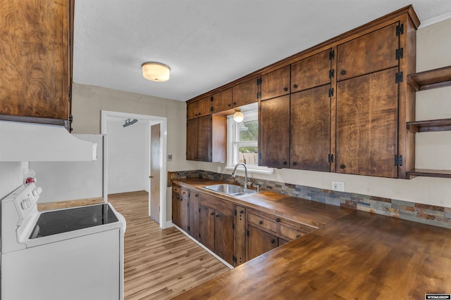 922 New Hampshire St, Rock Springs, WY 82901 - kitchen with electric stove, light wood finished floors, extractor fan, wooden counters, and open shelves
