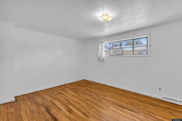 922 New Hampshire St, Rock Springs, WY 82901 - empty room featuring light wood-style floors and a textured ceiling
