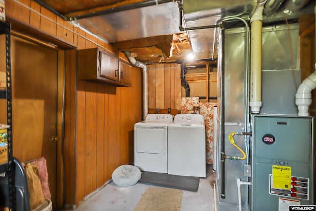 301 Cottonwood St, Evanston, WY 82930 - laundry room with separate washer and dryer, wood walls, and heating unit
