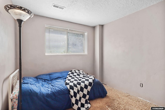 301 Cottonwood St, Evanston, WY 82930 - bedroom featuring carpet floors and a textured ceiling
