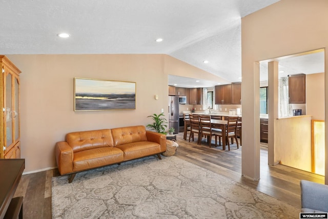 301 Cottonwood St, Evanston, WY 82930 - living area featuring wood finished floors, lofted ceiling, and recessed lighting