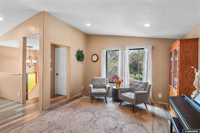 301 Cottonwood St, Evanston, WY 82930 - living area featuring wood finished floors, a chandelier, lofted ceiling, a textured ceiling, and recessed lighting