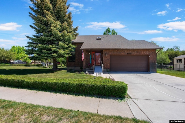 606 Herschler Ave, Evanston, WY 82930 - view of front of house featuring an attached garage, driveway, and brick siding