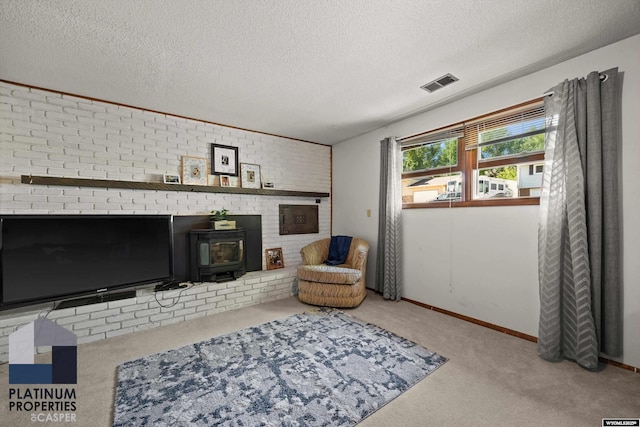 3440 E 18th St, Casper, WY 82609 - carpeted living room with a wood stove and a textured ceiling