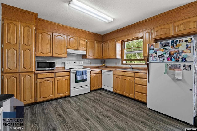 3440 E 18th St, Casper, WY 82609 - kitchen featuring white appliances, under cabinet range hood, light countertops, tasteful backsplash, and a textured ceiling