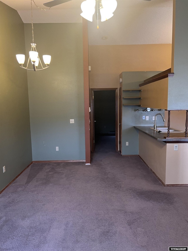 6358 Buckboard Rd, Casper, WY 82604 - kitchen featuring a chandelier, carpet floors, a ceiling fan, and hanging light fixtures