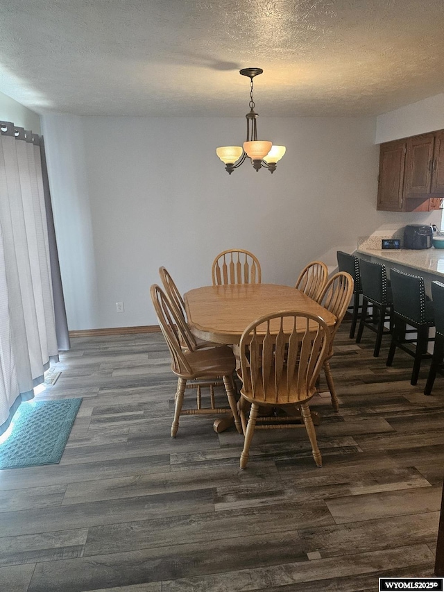 1150 Park View Dr, Green River, WY 82935 - dining space with dark wood-style floors, a textured ceiling, and a chandelier