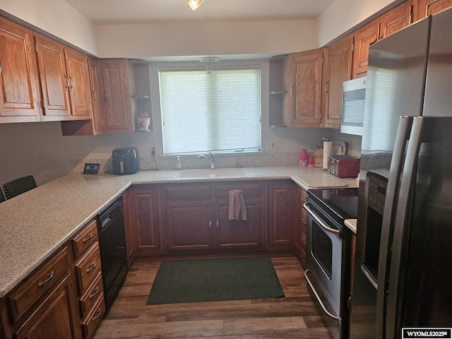 1150 Park View Dr, Green River, WY 82935 - kitchen featuring appliances with stainless steel finishes, light countertops, dark wood-style flooring, and brown cabinetry