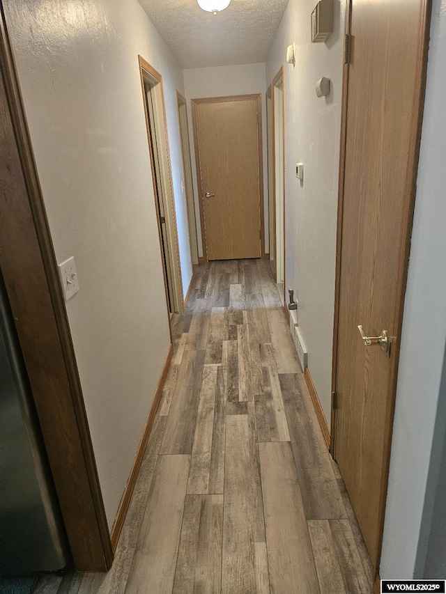 1150 Park View Dr, Green River, WY 82935 - corridor featuring light wood-style floors and a textured ceiling