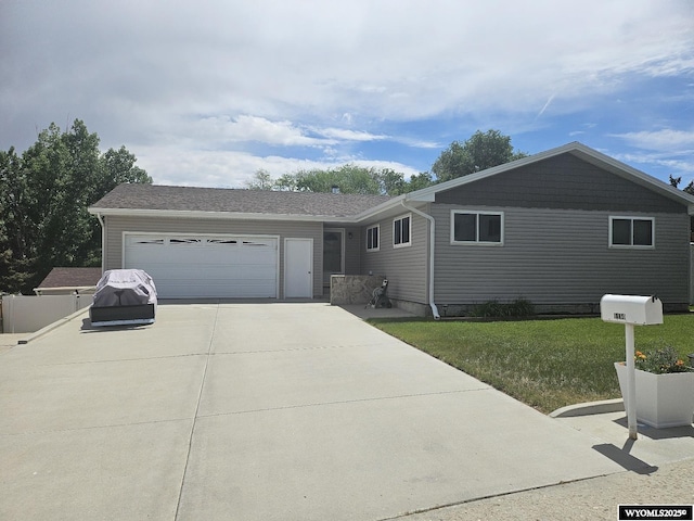 1150 Park View Dr, Green River, WY 82935 - ranch-style house with driveway, an attached garage, and a front lawn