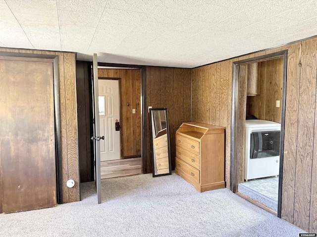 601 Diamondville Ave, Diamondville, WY 83116 - unfurnished bedroom featuring washer / clothes dryer, carpet floors, and wood walls