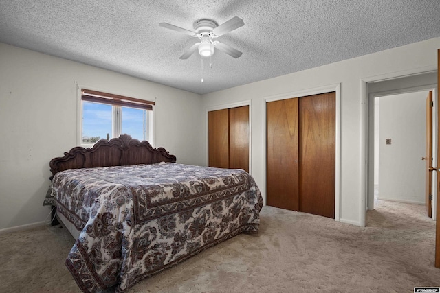 4450 S Skyline Rd, Casper, WY 82604 - carpeted bedroom with multiple closets, a textured ceiling, and a ceiling fan