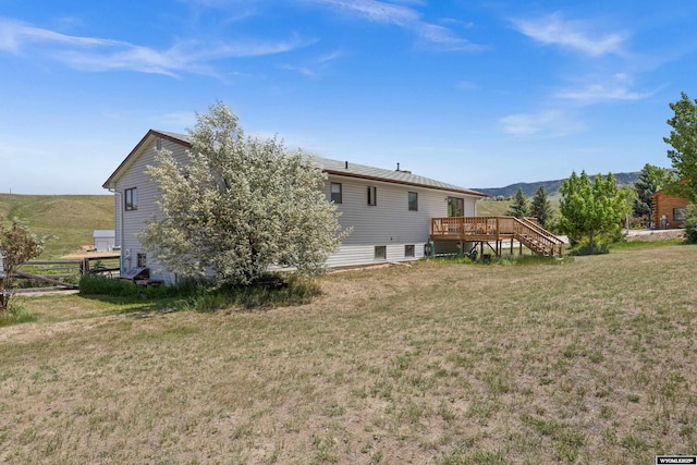 4450 S Skyline Rd, Casper, WY 82604 - back of house featuring a deck with mountain view, a lawn, and stairway
