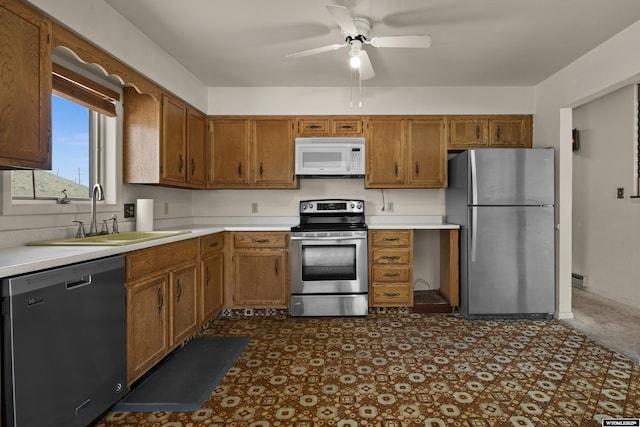 4450 S Skyline Rd, Casper, WY 82604 - kitchen featuring appliances with stainless steel finishes, brown cabinetry, and light countertops