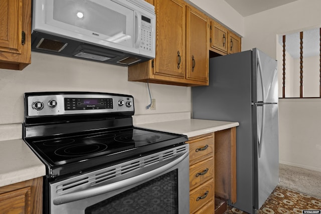 4450 S Skyline Rd, Casper, WY 82604 - kitchen with appliances with stainless steel finishes, brown cabinets, and light countertops