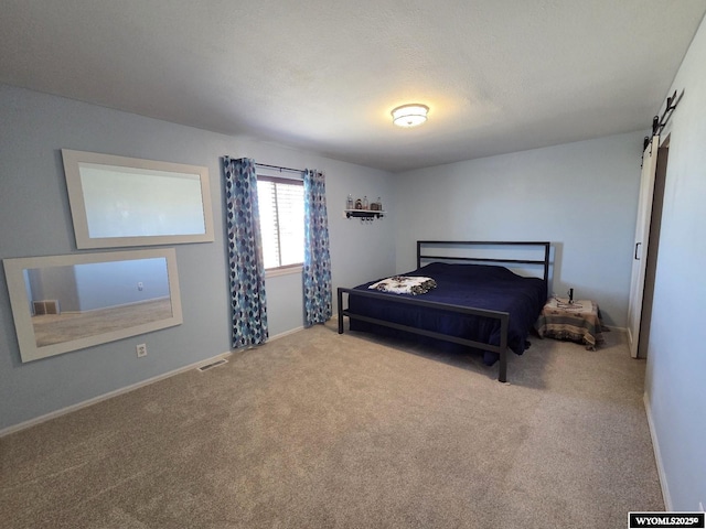 7866 Scorpion Way, Evansville, WY 82636 - bedroom featuring carpet floors and a barn door