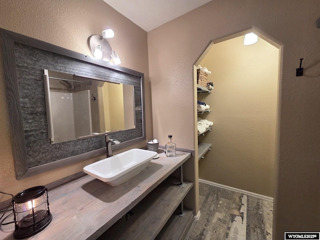 7866 Scorpion Way, Evansville, WY 82636 - bathroom with wood finished floors, vanity, and a shower