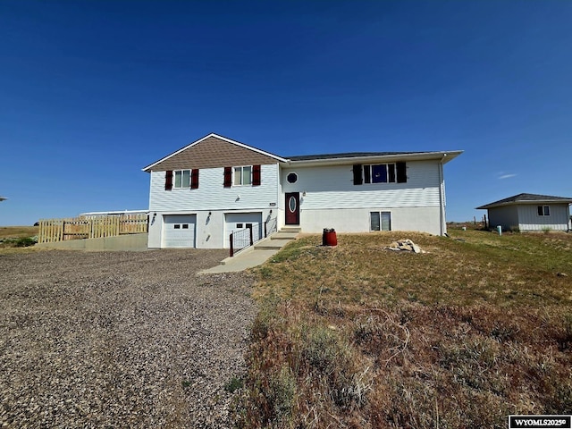 7866 Scorpion Way, Evansville, WY 82636 - bi-level home featuring an attached garage and gravel driveway