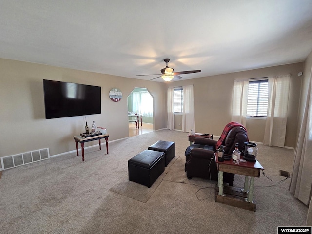 7866 Scorpion Way, Evansville, WY 82636 - living area with a ceiling fan, carpet, and arched walkways